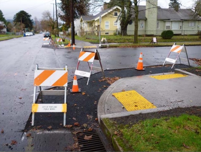 Sidewalk with construction barriers to crossing